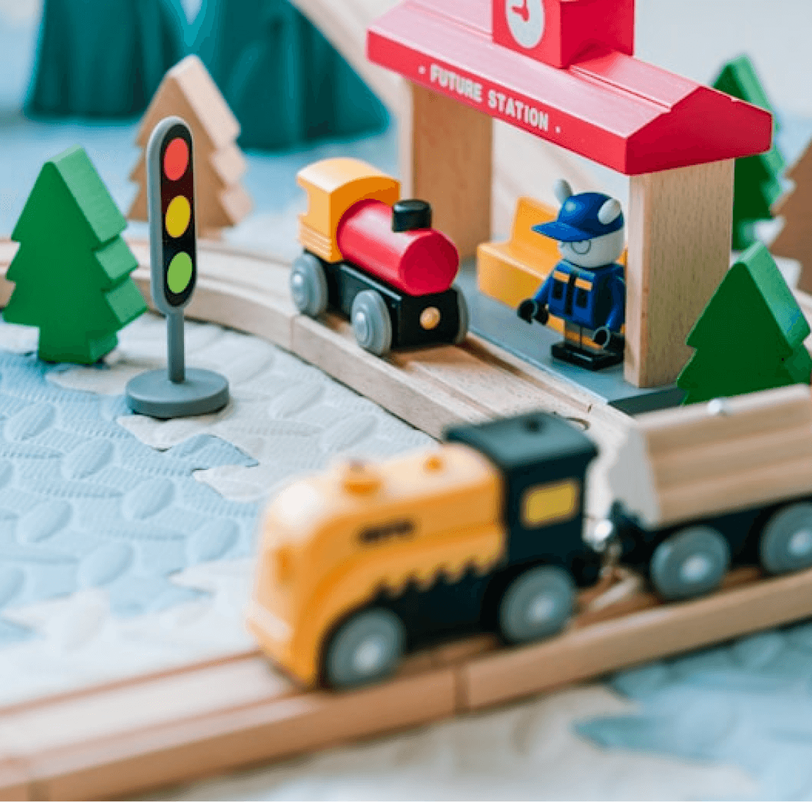 Wooden rainbow arc stacker arranged in a train play scene
